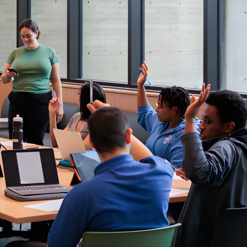 Several people sit around a long table, each raising a hand to show their agreement.