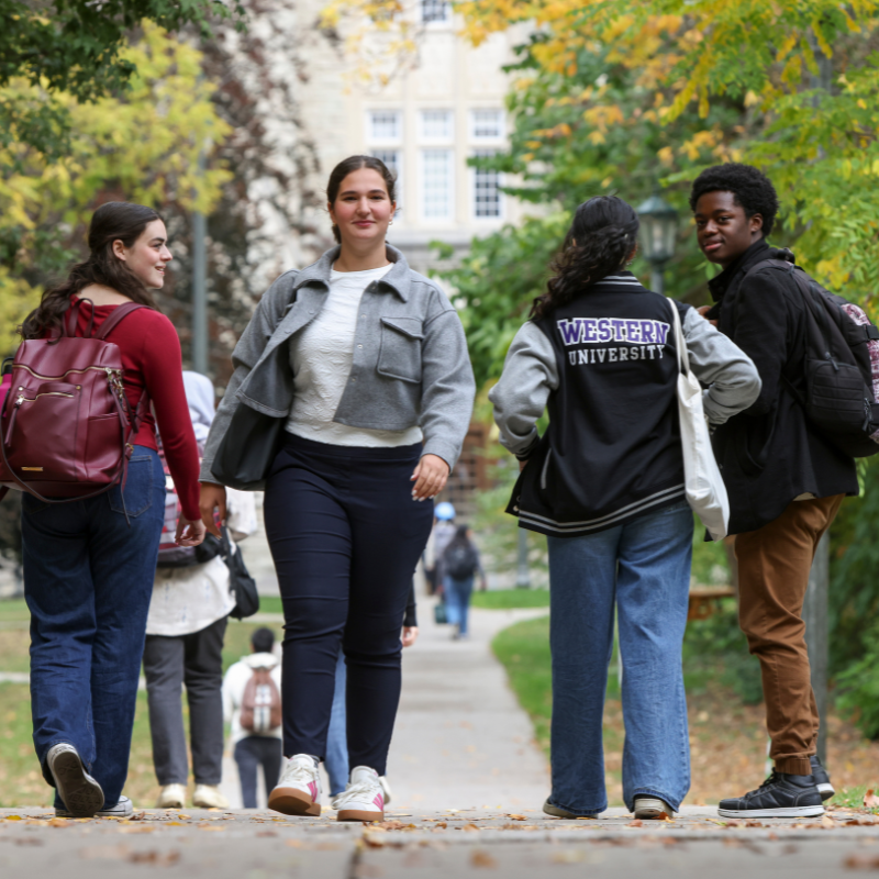 Four students walking outside on Western campus.