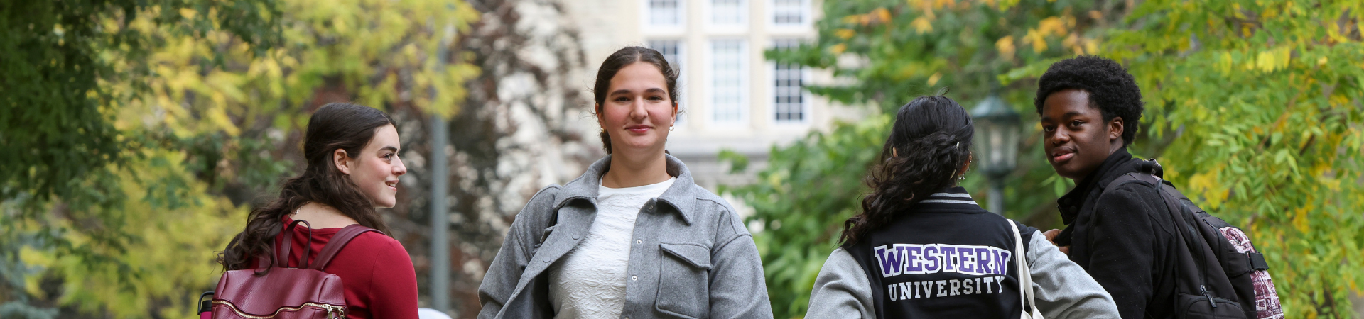Four students walking outside on Western campus.
